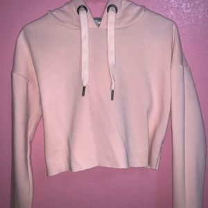 A light pink cropped hoodie.